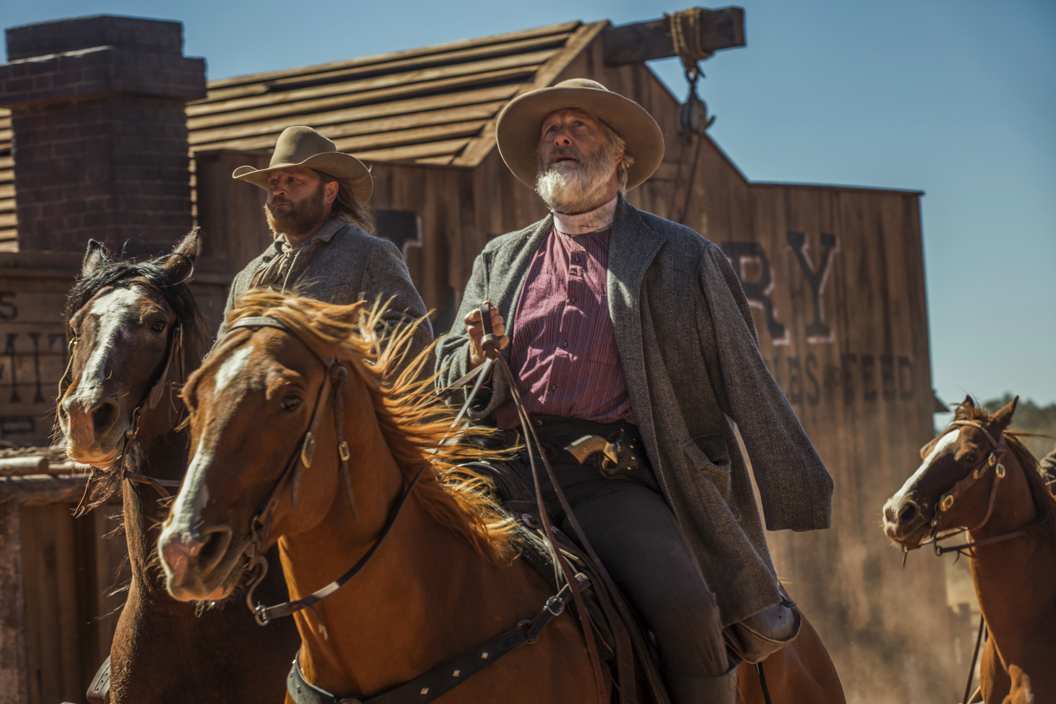 Jeff Daniels rides on horseback, with a revolver at his side, in Netflix’s Godless