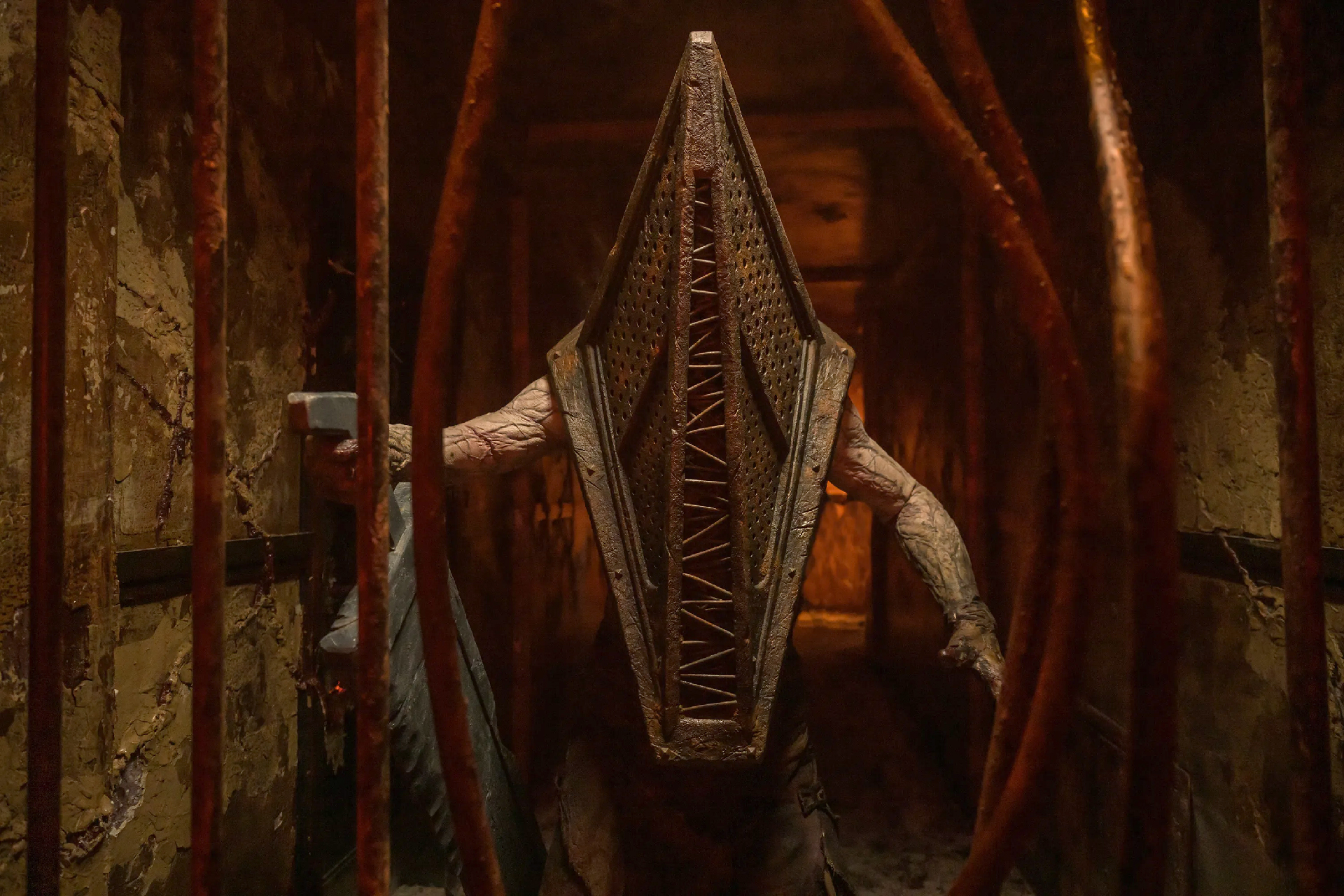An upper-body shot of Pyramid Head holding his giant slab blade in his right hand from the movie Return to Silent Hill